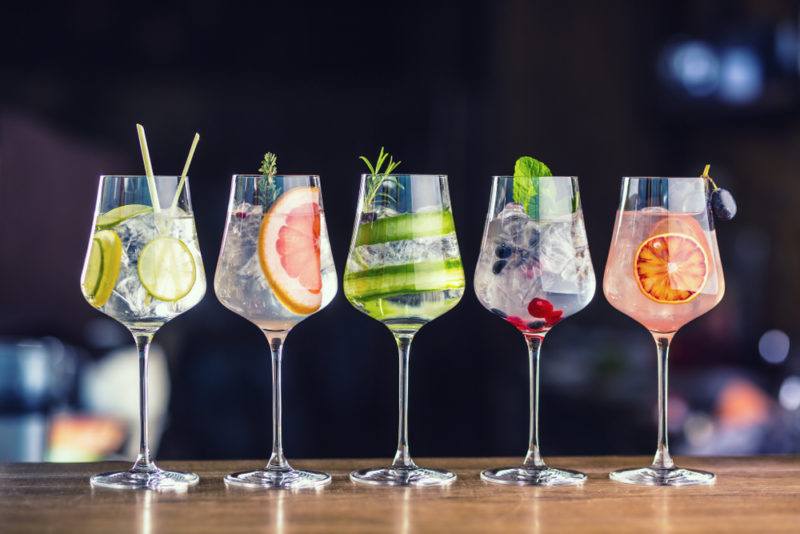 Five gin and tonics with different garnishes