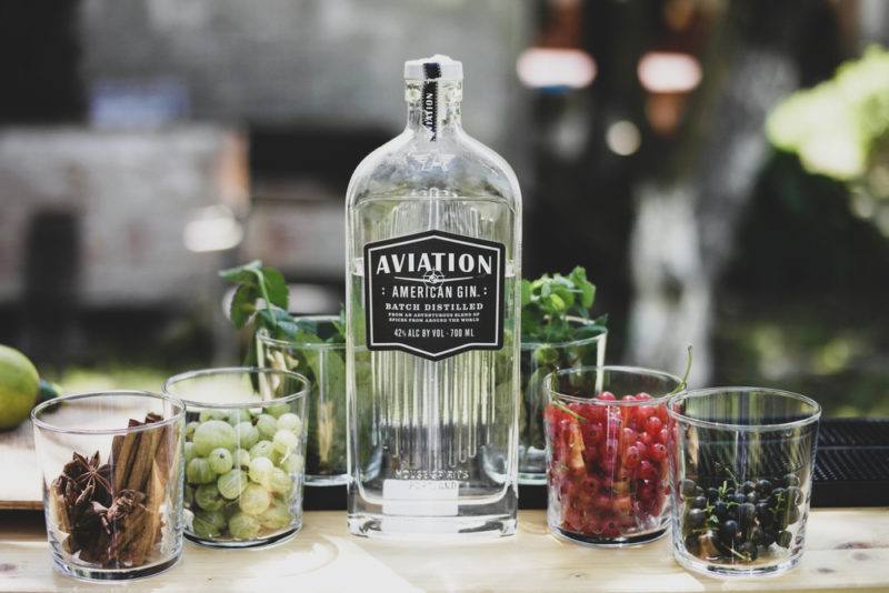 A bottle of American gin with glasses of aromatics