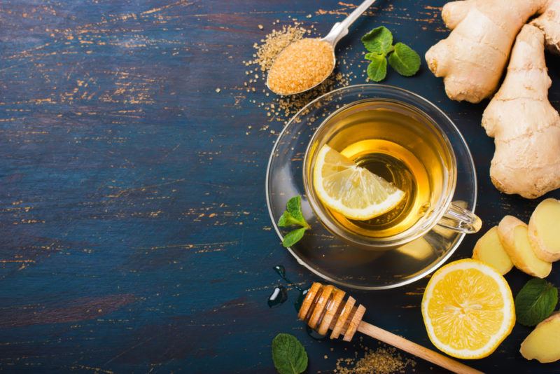 A top down image of a mug of ginger tea with honey