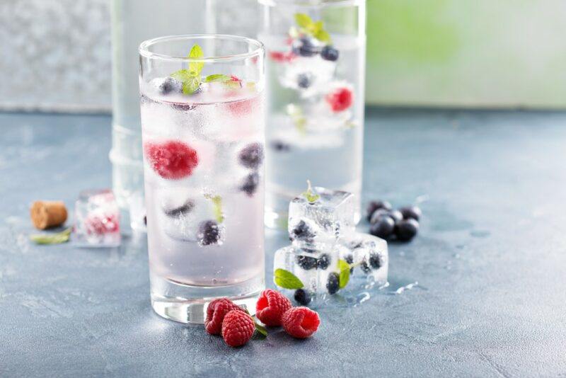 A few glasses of sparking water with berries and ice