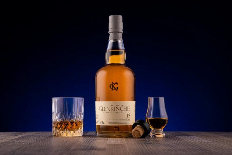 A bottle of Glenkinchie whisky next to two glasses of the whisky