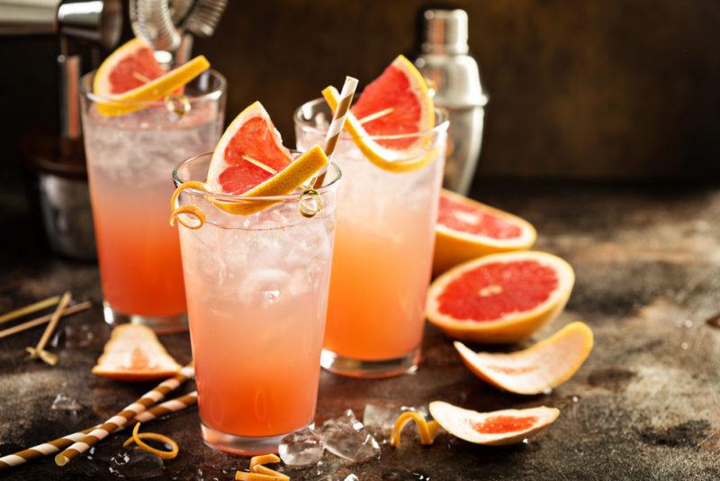 Three glasses of grapefruit soda with ice