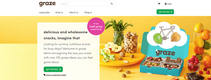 Graze website screenshot showing a range of snacks on a yellow table, along with a box from Graze that includes four different snacks.