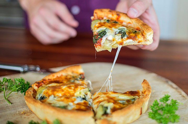 A deep dish pizza cut into 4 slices