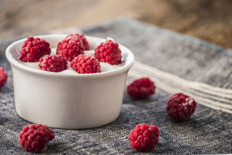 Greek yogurt in a bowl with raspberries