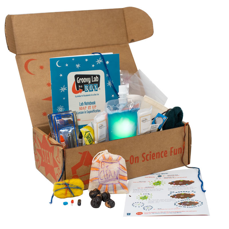 A cardboard box from the Groovy Lab in a Box company with various lab kits