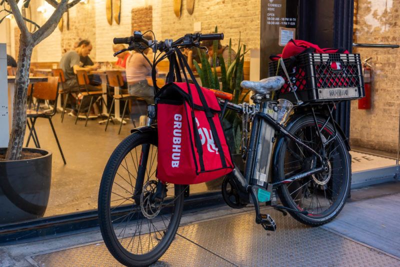 A Grubhub gig worker's bike parked outside a restaurant