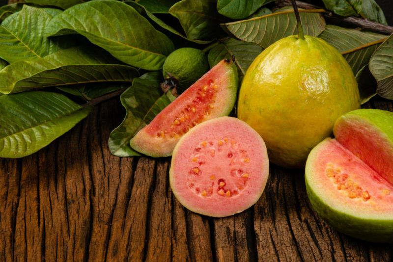 Guava wedges and fresh guava on a table