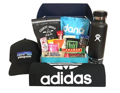 A black box with various snacks and an Adidas shirt