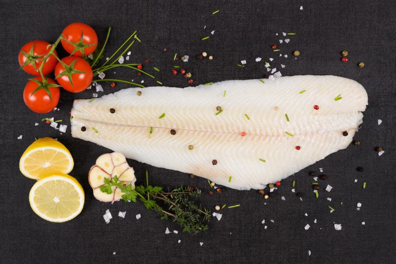 A Halibut fillet on a black background