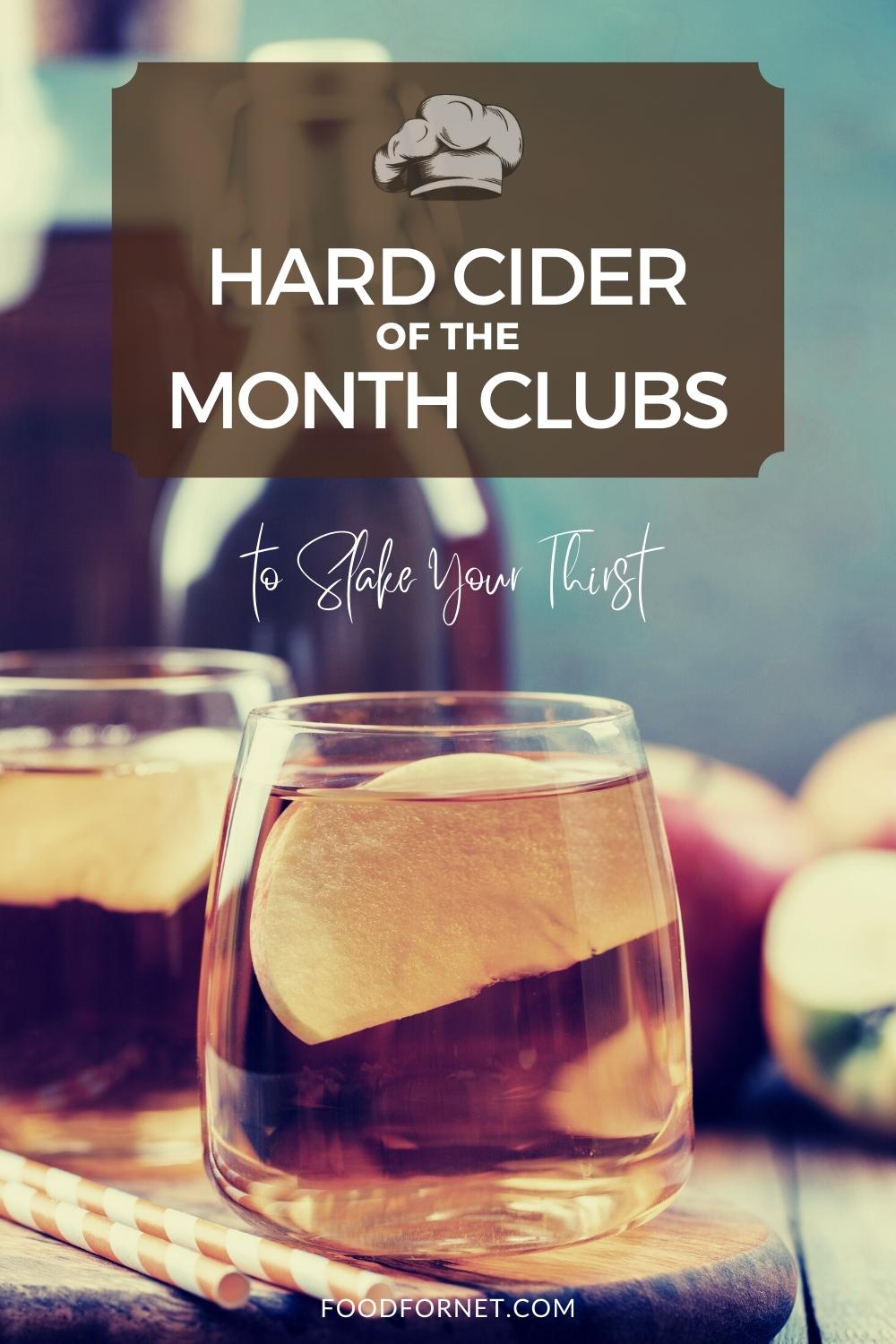 a couple of glasses of cider with fruit slices on a wooden board and bottle and apples at the back, with text overlay "Hard Cider of the Month Clubs to Slake Your Thirst"