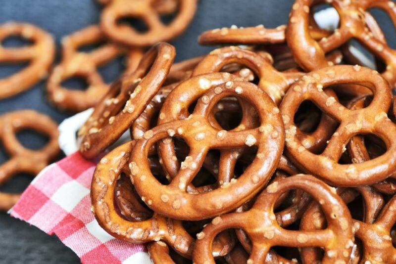 A red and white checkered cloth with hard pretzels on top of it