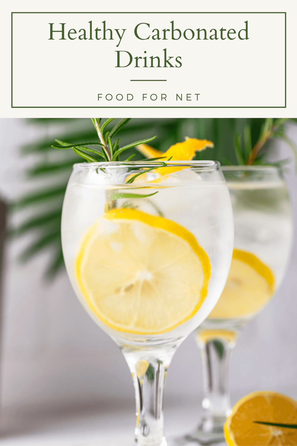 Healthy Carbonated Drinks. Two glasses of a healthy carbonated drink with rosemary and a slice of lemon