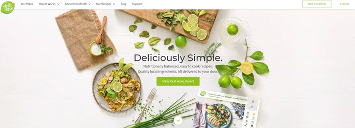 A white table with cooked food, chives and plenty of limes