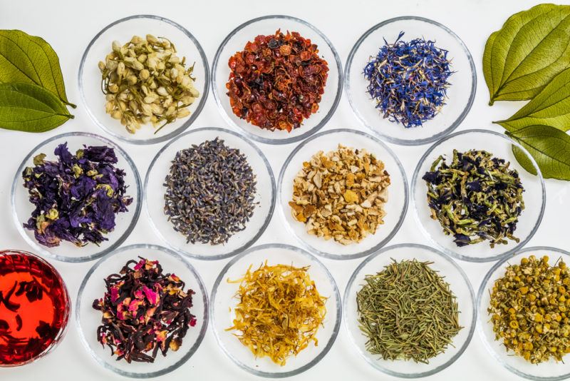 Small glass dishes containing variou tyles of herbal tea