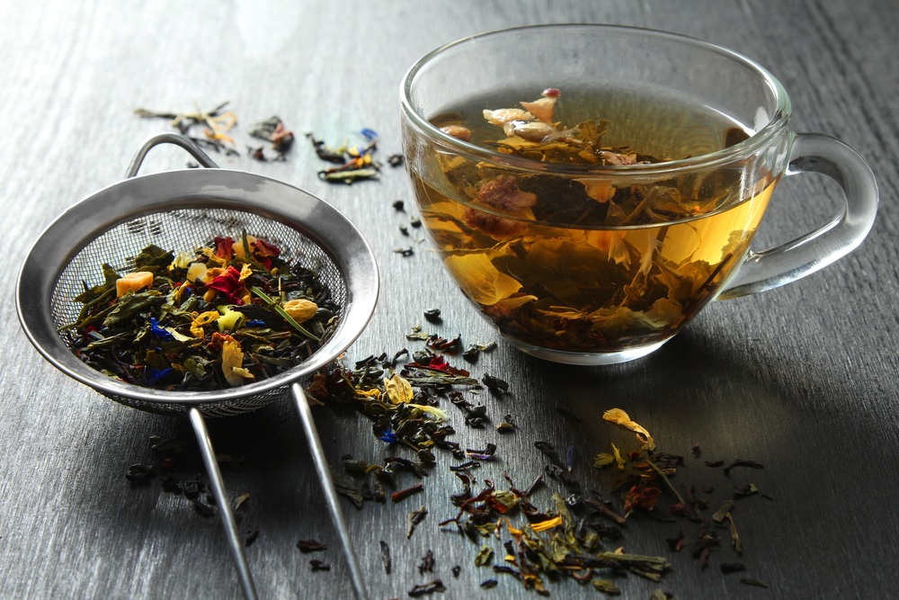 Herbal tea in a strainer and a glass