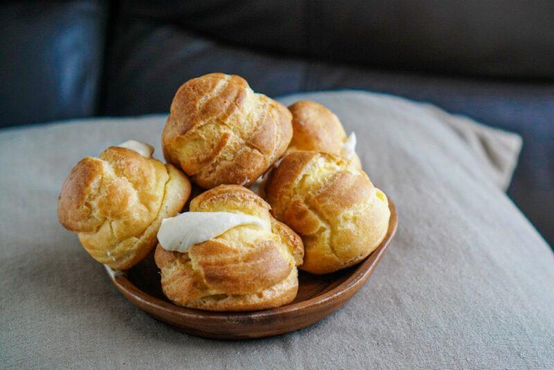 A brown bowl containing homemade cream puffs