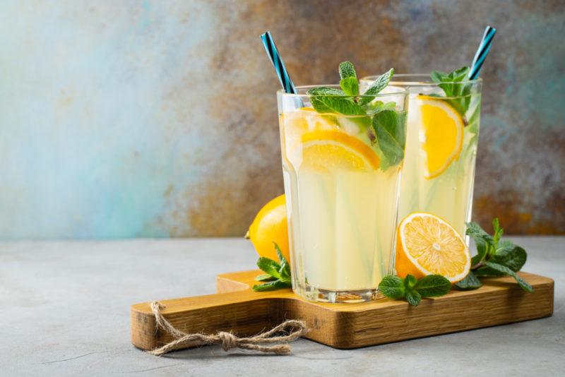 Two glasses of homemade lemonade on a wooden board