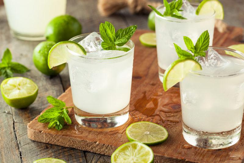 Three glasses of honey limeade on a wooden table