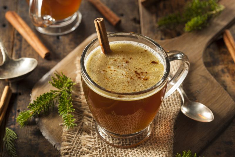 A glass mug containing hot buttered rum