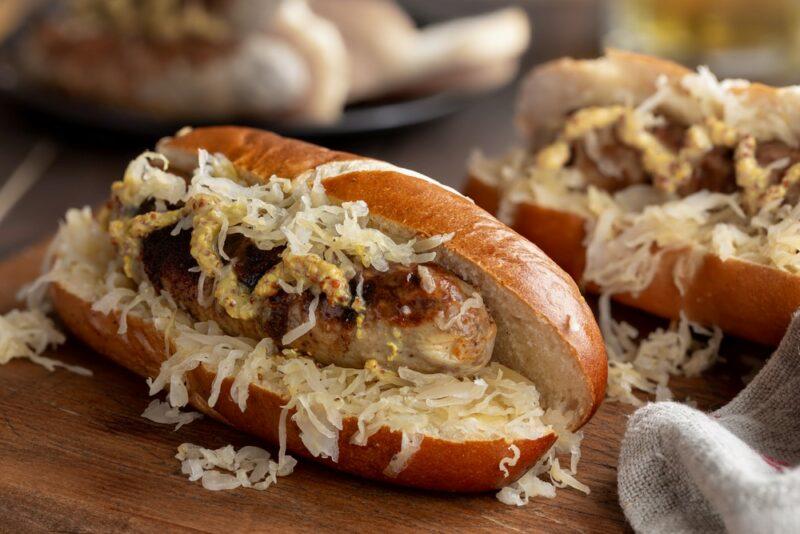 Two hot dog rolls filled with sauerkraut and a hot dog