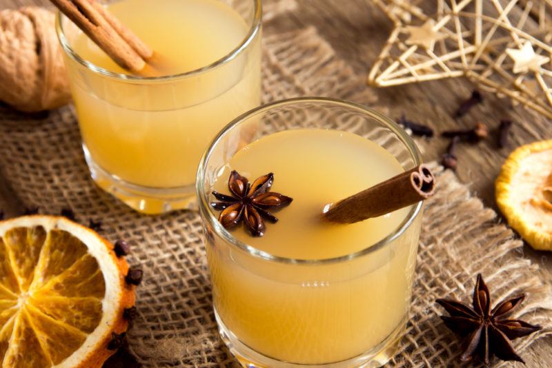 Two glass mugs of hot toddy, with cinnamon sticks and star anise