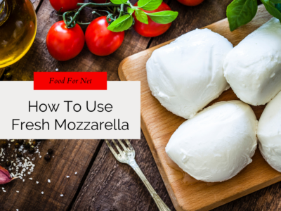 Four balls on fresh mozzarella cheese on a wooden board near some cherry tomatoes, looking at how to use fresh mozzarella