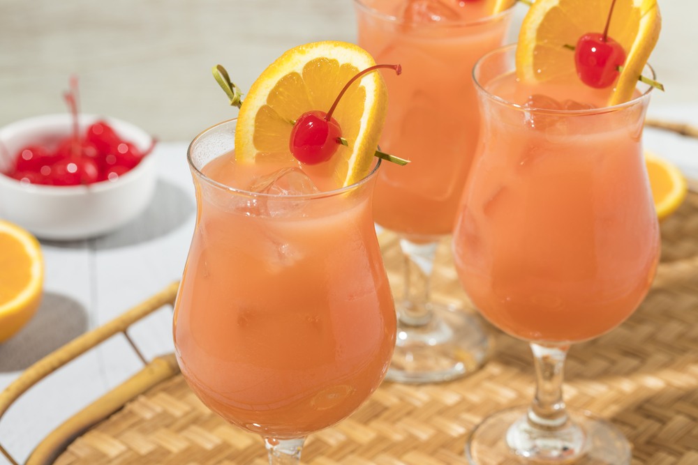 Three glasses of a hurricane cocktail with ice