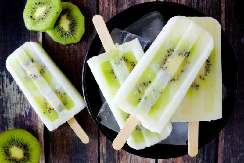 Four ice blocks that have been made using slices of kiwi