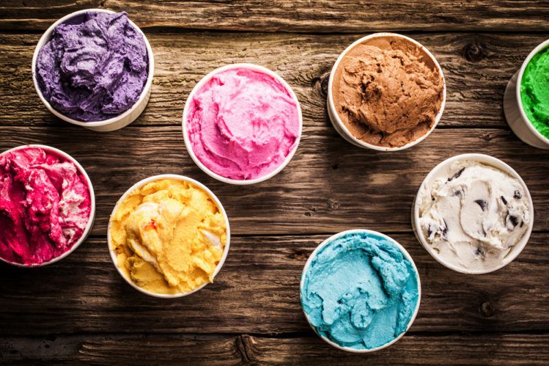 A top down image showing eight containers of ice cream in different colors