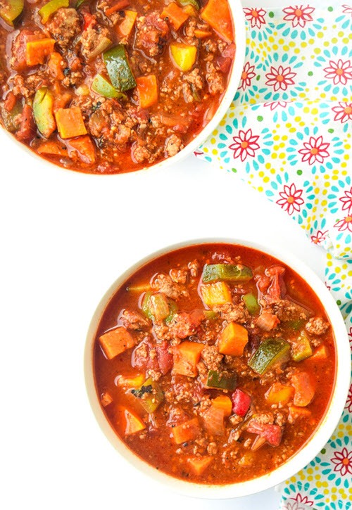 Two white bowls on a table with chili
