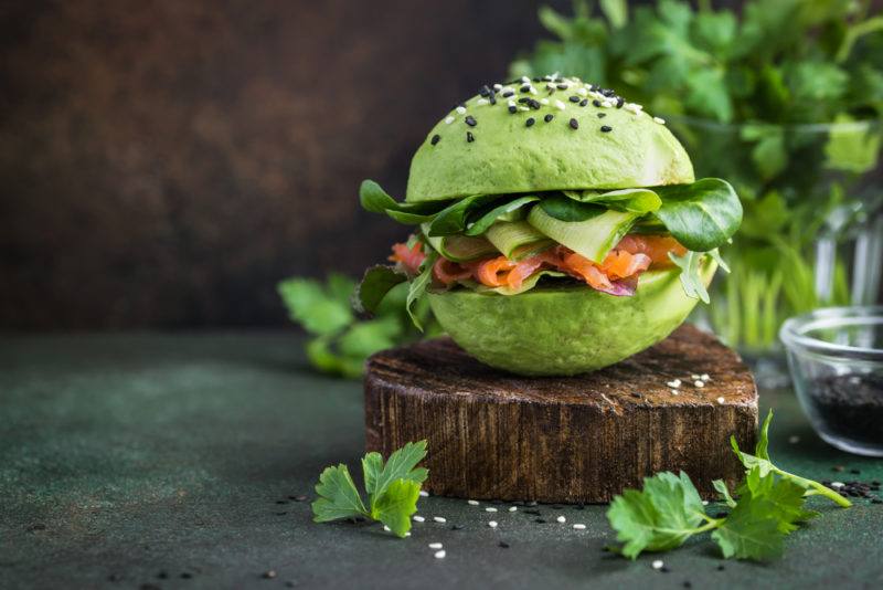 A buger made using avocado halfs instead of burger patties