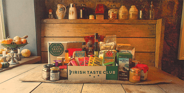 A selection of Irish products on a wooden table, in front of a wooden box.