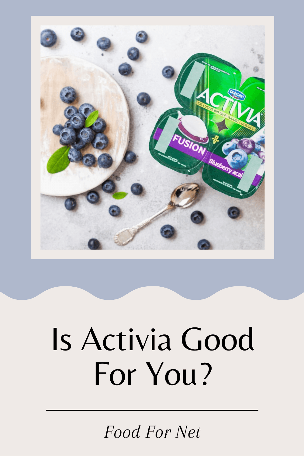 Four pottles of Activia yogurt, next to a bowl of the yogurt with blueberries and more blueberries on the table, looking at whether Activia yogurt is good for you