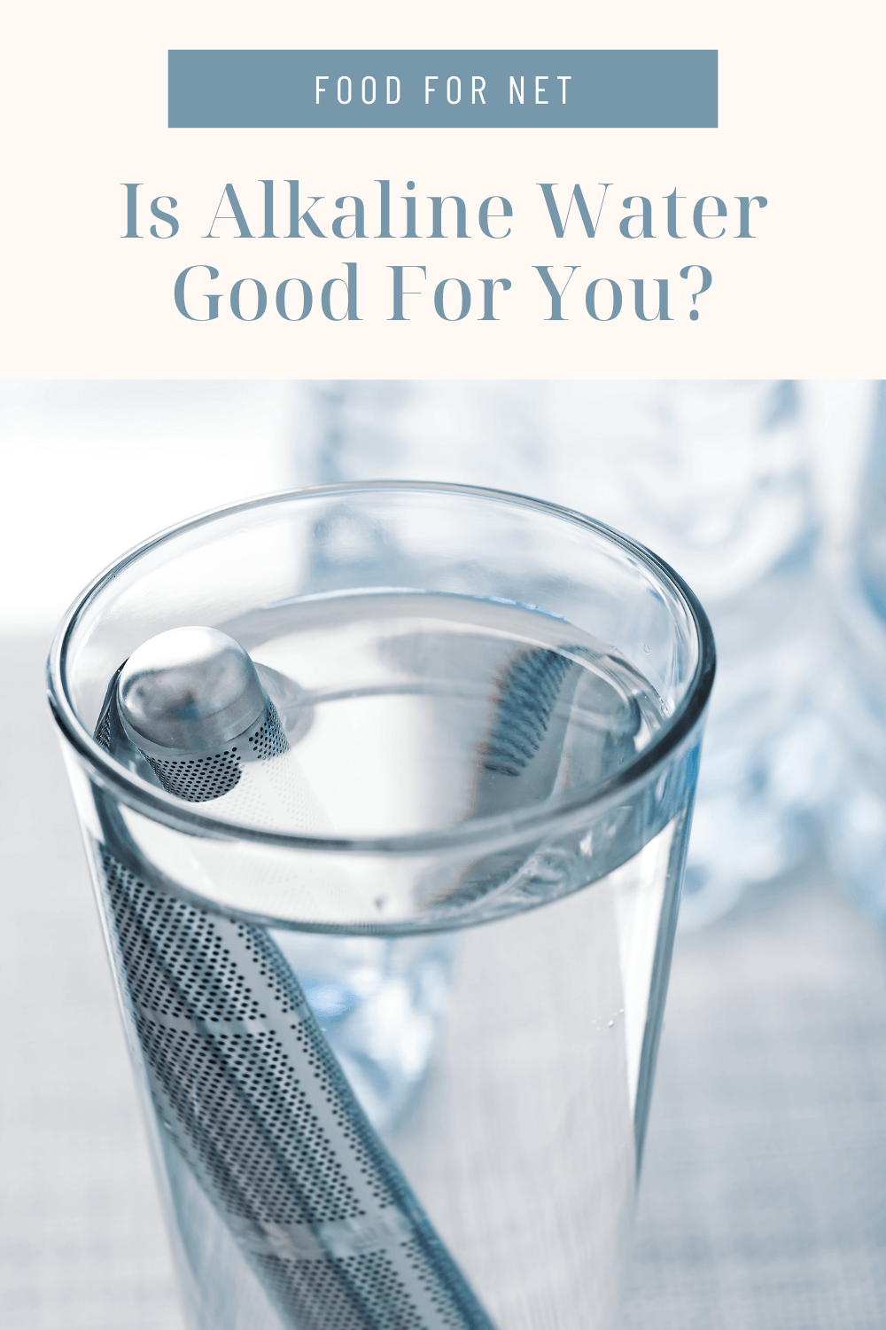 Is Alkaline Water Good For You? A glass of water on a table with an alkaline filter and bottles of water in the background