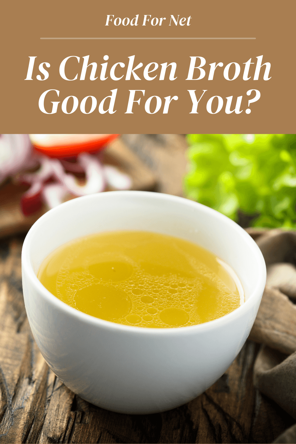 A small white bowl of chicken broth on a wooden table, looking at whether chicken broth is good for you