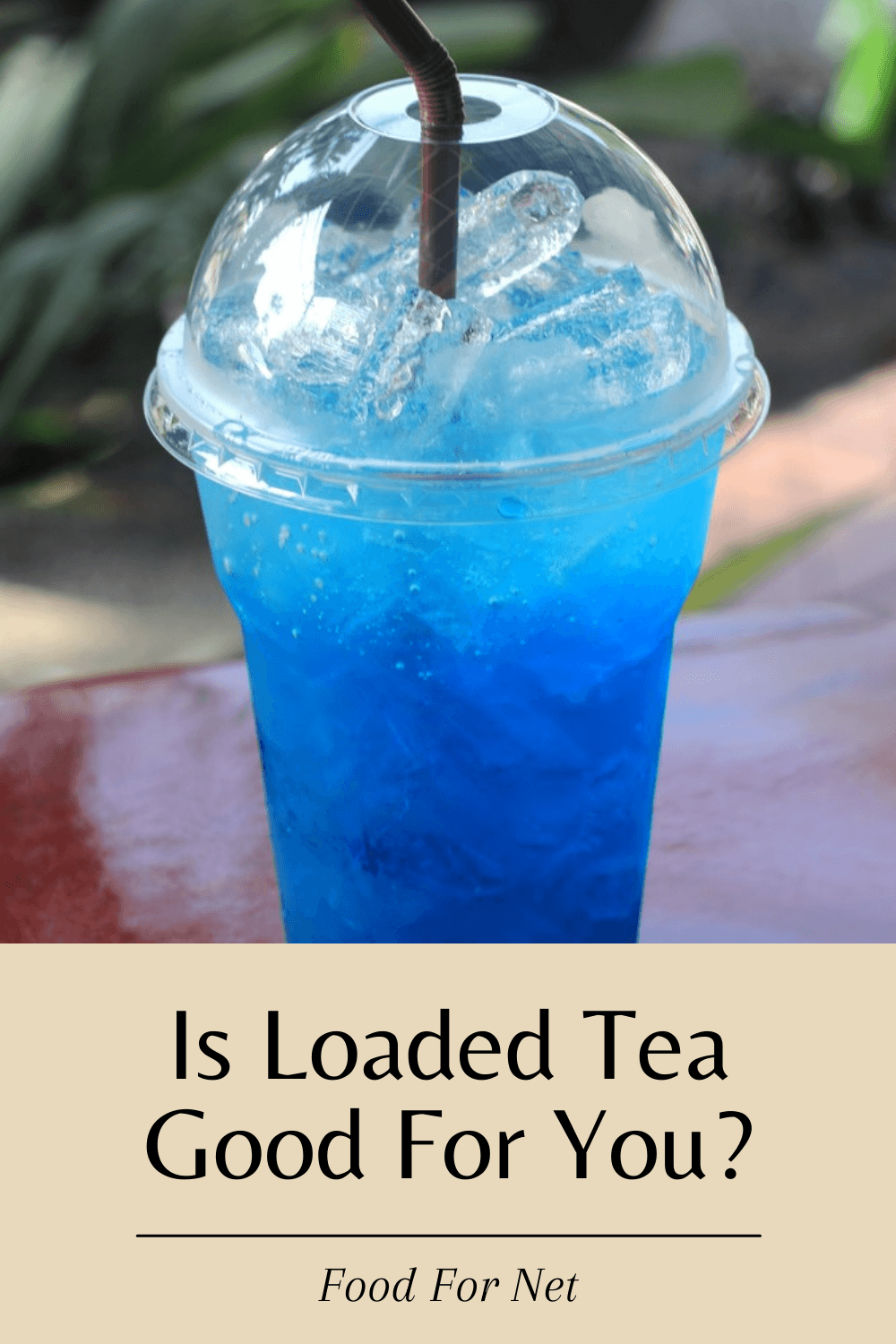 Blue layered tea in a plastic container with a straw and ice, highlighting the question of whether loaded tea is good for you