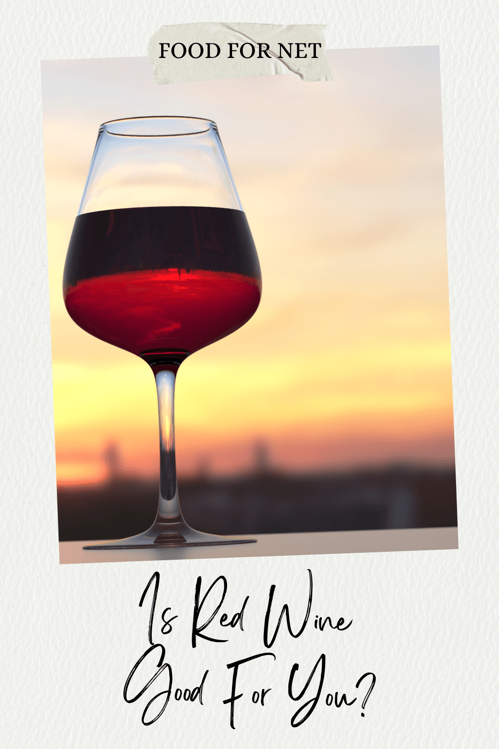 Is Red Wine Good For You? A glass of red wine on a table in front of a sunset or sunrise, asking whether red wine is good for you