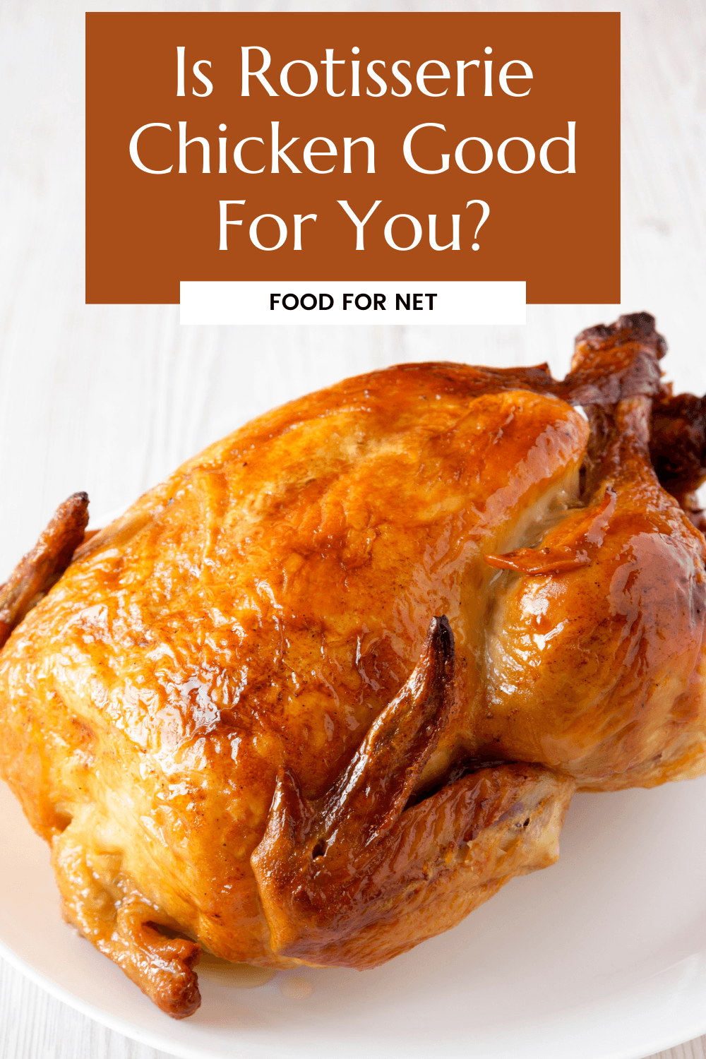 A rotisserie chicken on a white plate against a white background, looking at whether rotisserie chicken is good for you