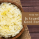 A wooden bowl of sauerkraut on a cloth