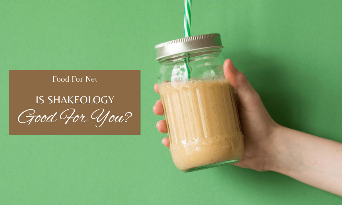 Someone holding up a shake in a mason jar against a light green background, looking at whether Shakeology is good for you