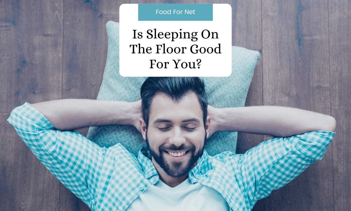 A happy man lying on the floor, with his hands behind his head, highlighting whether sleeping on the floor is good for you