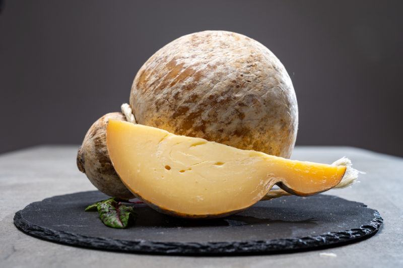 Italian semi hard matured caciocavallo cheese, handmade and aged in natural underground caves in Apulia region