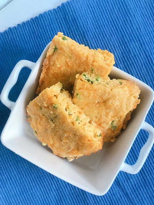 Jalapeno ‘Cornbread’ | Food For Net A square white dish containing three pieces of cornbread