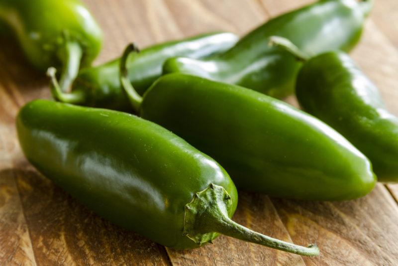 A selection of whole jalapenos on a table