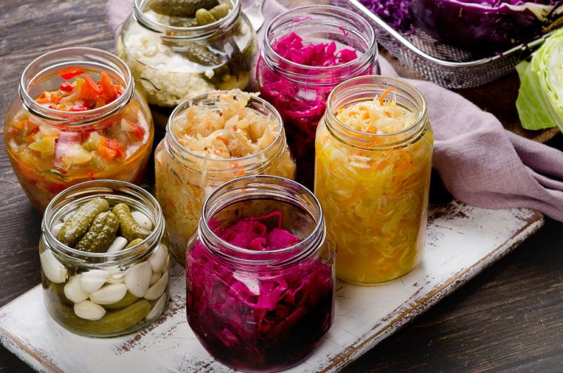 Multiple jars of fermented vegetables with salt