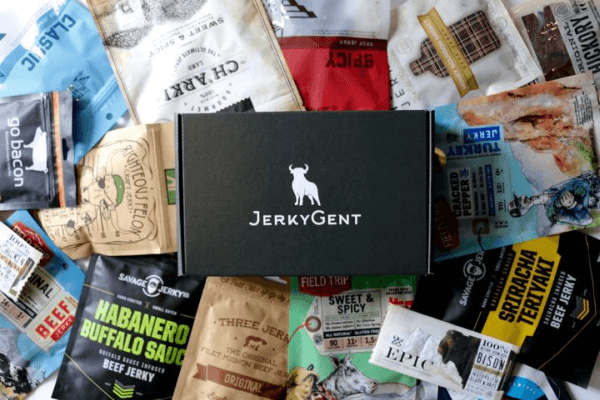 A JerkyGent subscription box on top of a wide selection of jerky