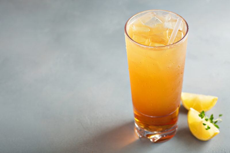 A John Daly cocktail on a table next to lemon wedges