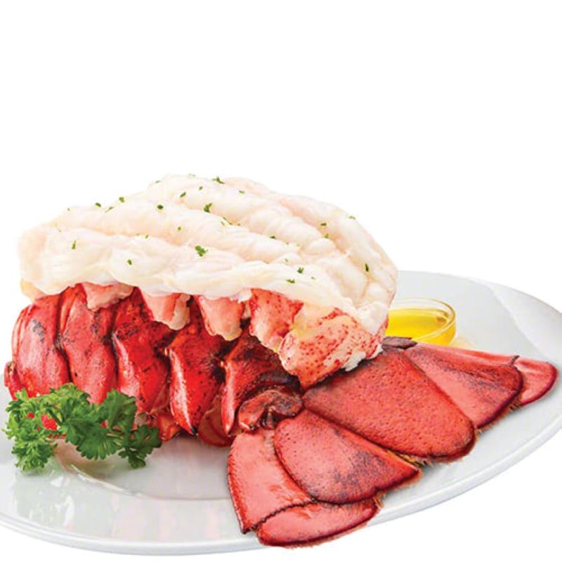 Jumbo-Lobster-Tails-1 | Food For Net Jumbo cooked lobster tail garnished with parsley, parsley sprig on the left and clarified butter on the right all sitting on a white plate
