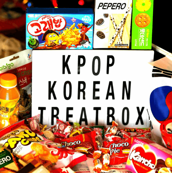 A selection of sweet Korean treats around a sign that says KPop Korean Treatbox